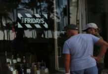 
			
				                                People peek into a window of a TGI Friday’s restaurant to see what they are serving to-go on Wednesday, March 25, 2020, in Miami Beach, Fla.
                                 AP File Photo

			
		